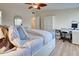 Main bedroom with king-size bed and an adjacent workspace at 647 White Pine Tree Rd # 34, Venice, FL 34285