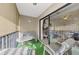 Spacious balcony with patio furniture and view of the living room at 756 White Pine Tree Rd # 211, Venice, FL 34285