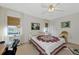 Well-lit bedroom with a queen bed and a home office area at 756 White Pine Tree Rd # 211, Venice, FL 34285