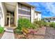 Exterior view of condo building with landscaped grounds and walkway at 756 White Pine Tree Rd # 211, Venice, FL 34285