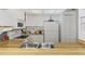 Bright kitchen with white cabinetry, wood countertops, and appliances at 756 White Pine Tree Rd # 211, Venice, FL 34285