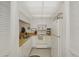 Efficient kitchen with white cabinets, wood countertops, and appliances at 756 White Pine Tree Rd # 211, Venice, FL 34285