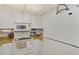 Galley kitchen with white appliances and wood countertops at 756 White Pine Tree Rd # 211, Venice, FL 34285