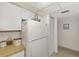 White kitchen with refrigerator, microwave, and stove at 756 White Pine Tree Rd # 211, Venice, FL 34285