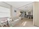 Open living area with view into guest bedroom and access to patio at 756 White Pine Tree Rd # 211, Venice, FL 34285