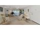 Living room with sliding doors to balcony and rocking chair at 756 White Pine Tree Rd # 211, Venice, FL 34285