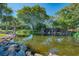 Serene pond with waterfall and lush landscaping at 756 White Pine Tree Rd # 211, Venice, FL 34285