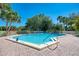 Community pool with lounge chairs and brick patio at 756 White Pine Tree Rd # 211, Venice, FL 34285