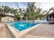 Community pool with lounge chairs and brick patio at 756 White Pine Tree Rd # 211, Venice, FL 34285