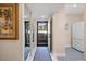 Bright entryway with mirror and view to patio at 784 Bird Bay Way # 105, Venice, FL 34285