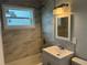 Modern bathroom with grey tile and white vanity at 8500 Agress Ave, North Port, FL 34287
