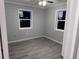 Spacious bedroom featuring wood-look floors and new windows at 8500 Agress Ave, North Port, FL 34287