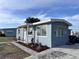 Side view of newly renovated light blue house at 8500 Agress Ave, North Port, FL 34287