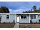 Newly renovated light blue house with landscaped yard at 8500 Agress Ave, North Port, FL 34287