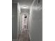 Clean hallway with light grey walls and wood-look floors at 8500 Agress Ave, North Port, FL 34287