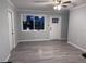 Bright living room with grey vinyl flooring and ceiling fan at 8500 Agress Ave, North Port, FL 34287