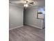 Living room with grey vinyl flooring and ceiling fan at 8500 Agress Ave, North Port, FL 34287