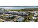 Aerial view of community featuring lush landscaping, tennis courts and waterfront views at 9203 Griggs Rd # B202, Englewood, FL 34224