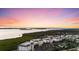 An aerial view of condo buildings along the water during a colorful sunset at 9203 Griggs Rd # B202, Englewood, FL 34224