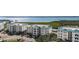 Aerial view of condo buildings, lush landscaping, and waterfront setting at 9203 Griggs Rd # B202, Englewood, FL 34224