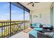 Relaxing balcony with plush lounge furniture and serene waterfront views at 9203 Griggs Rd # B202, Englewood, FL 34224