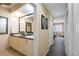 Bathroom featuring double sinks, granite countertops and decorative mirrors at 9203 Griggs Rd # B202, Englewood, FL 34224