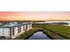 A beautiful view of the condo buildings, trees, and waterway during a colorful sunset at 9203 Griggs Rd # B202, Englewood, FL 34224