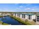 Exterior view of lovely condo complex with lake views and manicured lawns at 9203 Griggs Rd # B202, Englewood, FL 34224