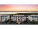 Aerial view of condo buildings with manicured landscaping and water views at 9203 Griggs Rd # B202, Englewood, FL 34224