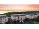 Condo buildings with lush greenery and a beautiful sunset backdrop at 9203 Griggs Rd # B202, Englewood, FL 34224
