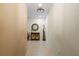 Bright hallway featuring decorative mirror, cabinet, and giraffe statue at 9203 Griggs Rd # B202, Englewood, FL 34224