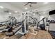 Well-equipped home gym featuring weight machines and mirrored walls at 9203 Griggs Rd # B202, Englewood, FL 34224