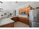 Modern kitchen featuring wooden cabinets, updated appliances and white countertop at 9203 Griggs Rd # B202, Englewood, FL 34224