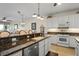 Kitchen featuring white cabinets and stainless steel appliances at 9203 Griggs Rd # B202, Englewood, FL 34224