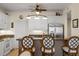 Kitchen with white cabinets, granite countertops, stainless steel refrigerator, and bar seating at 9203 Griggs Rd # B202, Englewood, FL 34224
