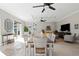 Spacious living room featuring tile floors, ceiling fans and large sliding glass doors to the outside patio at 9203 Griggs Rd # B202, Englewood, FL 34224