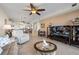 Open concept living area featuring tile flooring, modern furniture, and open access to the kitchen at 9203 Griggs Rd # B202, Englewood, FL 34224