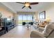 Bright living room featuring neutral tones, modern furnishings and sliding glass doors to the outdoor balcony at 9203 Griggs Rd # B202, Englewood, FL 34224