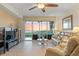 Bright living room with tile floors, comfortable seating, and stunning water views from the balcony at 9203 Griggs Rd # B202, Englewood, FL 34224