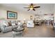 Open concept living room and dining room area with tile flooring and neutral color palette at 9203 Griggs Rd # B202, Englewood, FL 34224