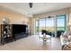 Open-plan living space features a large window, ceramic tile floor, and comfortable seating at 9203 Griggs Rd # B202, Englewood, FL 34224