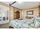 Well-decorated bedroom showcasing a canopy bed with decorative pillows and access to a covered balcony at 9203 Griggs Rd # B202, Englewood, FL 34224