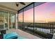 Relaxing screened porch with blue patio chairs and lovely views of the water at 9203 Griggs Rd # B202, Englewood, FL 34224