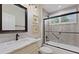 Bathroom with marble vanity and bathtub at 1010 Grouse Way, Venice, FL 34285