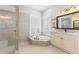 Elegant bathroom with soaking tub, walk-in shower, and double vanity at 1010 Grouse Way, Venice, FL 34285