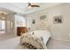 Elegant bedroom with ornate bed frame and ceiling fan at 1010 Grouse Way, Venice, FL 34285