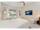 Main bedroom with pool view and large TV at 1010 Grouse Way, Venice, FL 34285