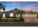 Elegant one-story home with two-car garage and manicured lawn at 1010 Grouse Way, Venice, FL 34285