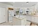 Island kitchen features granite counters, white cabinets, and breakfast bar at 1010 Grouse Way, Venice, FL 34285