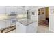 Bright kitchen with granite island and white cabinets at 1010 Grouse Way, Venice, FL 34285